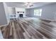 Bright living room featuring a brick fireplace, built-in bookshelves, and sleek, modern flooring at 103 N Nebraska St, North Salem, IN 46165
