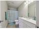 Well-lit bathroom featuring a large vanity, toilet, and shower with stylish curtain at 10881 August Dr, Ingalls, IN 46048