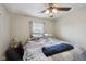 Bedroom featuring a ceiling fan, a window, and a comfortable bed with a side table at 10881 August Dr, Ingalls, IN 46048