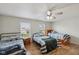 Bright bedroom with three twin beds, wood floors, and a ceiling fan at 10881 August Dr, Ingalls, IN 46048