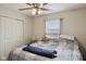 Bedroom featuring a ceiling fan, closet and a comfortably made bed with a window at 10881 August Dr, Ingalls, IN 46048