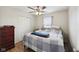 Bedroom featuring a bed, ceiling fan, side table and hardwood floors at 10881 August Dr, Ingalls, IN 46048