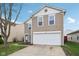Charming home featuring a two-car garage and a well-maintained lawn at 10881 August Dr, Ingalls, IN 46048