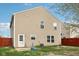 Exterior rear view with tan siding, lawn and an enclosed yard at 10881 August Dr, Ingalls, IN 46048
