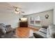 Comfortable living room with hardwood floors, a ceiling fan, and large windows at 10881 August Dr, Ingalls, IN 46048