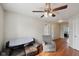 Cozy living room with hardwood floors, a ceiling fan, and comfortable seating area at 10881 August Dr, Ingalls, IN 46048