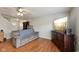 Bright living room featuring hardwood floors, comfortable sofa, and a TV at 10881 August Dr, Ingalls, IN 46048