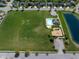 Vast community space with a pool, playground, pond, and green space, promoting an active lifestyle at 11014 Woodpark Dr, Noblesville, IN 46060