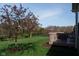 An outdoor view showcases a deck surrounded by a well-maintained yard, with a pink blooming tree at 11014 Woodpark Dr, Noblesville, IN 46060