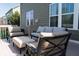 A backyard deck has a gray sofa, comfortable chairs, and ottoman for enjoyable outdoor relaxation at 11014 Woodpark Dr, Noblesville, IN 46060