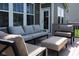 The backyard deck has a cozy gray sofa, two comfortable chairs and an ottoman for outdoor relaxation at 11014 Woodpark Dr, Noblesville, IN 46060