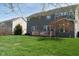 Large backyard with green grass, mature trees, and a wooden deck at 11014 Woodpark Dr, Noblesville, IN 46060