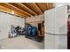 Unfinished basement with exposed beams, storage solutions, and a treadmill at 11014 Woodpark Dr, Noblesville, IN 46060