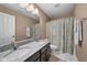 Bathroom featuring a double vanity with granite countertop and a shower/tub with curtain at 11014 Woodpark Dr, Noblesville, IN 46060