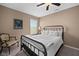 Bedroom featuring a black metal frame bed, neutral walls, carpet flooring, and natural light from the window at 11014 Woodpark Dr, Noblesville, IN 46060