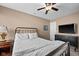 Bedroom featuring a black metal frame bed, neutral walls, carpet flooring, and natural light from the window at 11014 Woodpark Dr, Noblesville, IN 46060