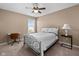 Cozy bedroom features a metal frame bed, neutral walls, carpet flooring, and natural light from the window at 11014 Woodpark Dr, Noblesville, IN 46060