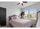Bright bedroom with two windows offering plenty of natural light, and a stylish upholstered bed at 11014 Woodpark Dr, Noblesville, IN 46060
