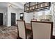 Open-concept dining room features a modern light fixture, wood table, and stylish decor at 11014 Woodpark Dr, Noblesville, IN 46060