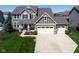 Inviting two-story home with a gray facade, manicured lawn, and a spacious driveway leading to a two-car garage at 11014 Woodpark Dr, Noblesville, IN 46060
