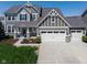 Inviting two-story home with a gray facade, manicured lawn, and a spacious driveway leading to a two-car garage at 11014 Woodpark Dr, Noblesville, IN 46060