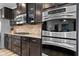 Kitchen featuring stainless steel appliances and wooden cabinets with tile backsplash at 11014 Woodpark Dr, Noblesville, IN 46060