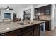 Kitchen island with stainless steel sink, granite countertop and wooden cabinets at 11014 Woodpark Dr, Noblesville, IN 46060
