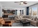 Open-concept living space with a spacious seating area connected to a modern kitchen with an island and bar stools at 11014 Woodpark Dr, Noblesville, IN 46060