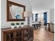 Elegant interior featuring a wooden cabinet, mirror, and an open view of the dining area and living room at 11014 Woodpark Dr, Noblesville, IN 46060