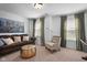 Inviting living room with neutral walls, plush seating, soft natural light, and contemporary decor at 11014 Woodpark Dr, Noblesville, IN 46060