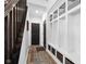 Functional mudroom with built-in storage cubbies, bench, and dark wood accents for organization and style at 11014 Woodpark Dr, Noblesville, IN 46060