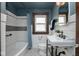 Traditional bathroom with white subway tile, pedestal sink, and black and white mosaic tile flooring at 1116 N Linwood Ave, Indianapolis, IN 46201