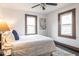 Comfortable bedroom featuring neutral accents, natural light, and black hardwood floors at 1116 N Linwood Ave, Indianapolis, IN 46201