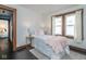 Bedroom with pink accents, natural light, dark wood trim, and black hardwood floors at 1116 N Linwood Ave, Indianapolis, IN 46201