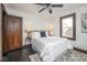 Bedroom with white comforter, gray accents, and dark wood trim and floors at 1116 N Linwood Ave, Indianapolis, IN 46201