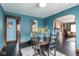 Dining room featuring dark floors, an archway to the living room and a hanging light at 1116 N Linwood Ave, Indianapolis, IN 46201