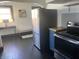 Modern kitchen featuring stainless steel appliances, including a sleek refrigerator and a range with a glass top at 1116 N Linwood Ave, Indianapolis, IN 46201