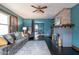 Comfortable living room with hardwood floors, large window, fireplace, and view to dining room at 1116 N Linwood Ave, Indianapolis, IN 46201