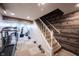 Basement featuring wood accent wall, carpet floors, a staircase, and exercise equipment at 1123 Barley Cir, Carmel, IN 46032