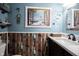 Detailed view of bathroom vanity with unique beach-themed wall art and wood-style wall paneling at 1123 Barley Cir, Carmel, IN 46032