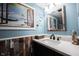 Charming bathroom with a decorative wood accent wall and beach-themed decor at 1123 Barley Cir, Carmel, IN 46032