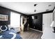 Bedroom with a single bed, black accent wall, and a window bringing in natural light at 1123 Barley Cir, Carmel, IN 46032