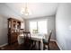 Bright dining room featuring a wooden table, hutch, chandelier, and large windows at 1123 Barley Cir, Carmel, IN 46032