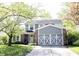 Charming two-story home featuring a brick facade, gray siding, and a beautifully landscaped front yard at 1123 Barley Cir, Carmel, IN 46032