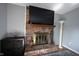 Close-up of brick fireplace with mantle and decor in a cozy living room setting at 1123 Barley Cir, Carmel, IN 46032