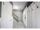 Bright foyer with white paneled walls, tiled floors, and staircase with carpeted steps at 1123 Barley Cir, Carmel, IN 46032
