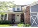 Inviting front porch with brick accents, comfortable seating, and fresh landscaping at 1123 Barley Cir, Carmel, IN 46032