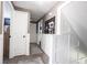 Upstairs hallway featuring white trim, decorative wall storage and wood look flooring at 1123 Barley Cir, Carmel, IN 46032