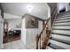 Bright hallway with white wainscoting, staircase and a view of the living room at 1123 Barley Cir, Carmel, IN 46032