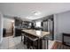Contemporary kitchen with a large island, stainless steel appliances, and rustic wood accent wall at 1123 Barley Cir, Carmel, IN 46032